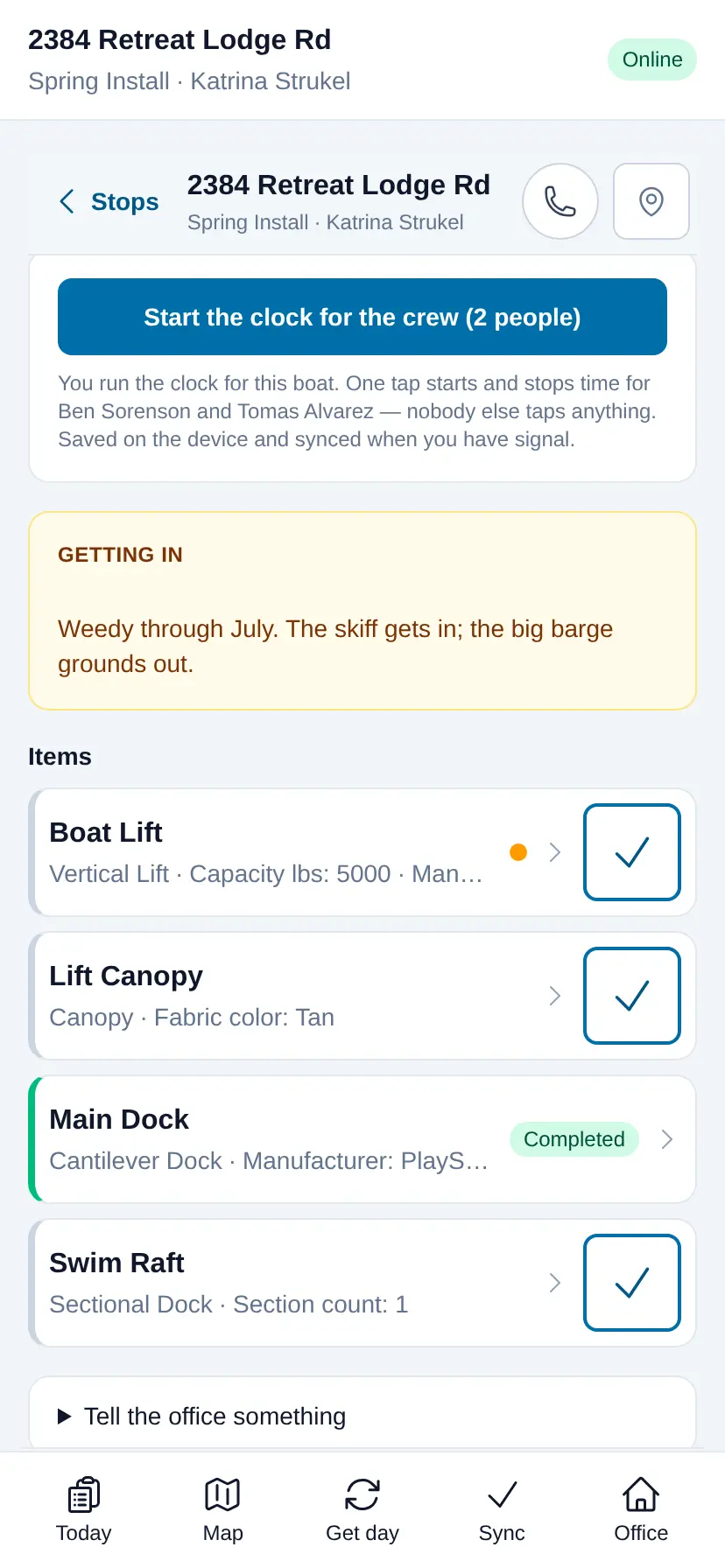 The LakeOps crew app on a phone: the property address, start and stop clock buttons, an access note reading “Weedy through July — the skiff gets in, the big barge grounds out”, and each piece of equipment with its install note, a photo button and a Mark done button